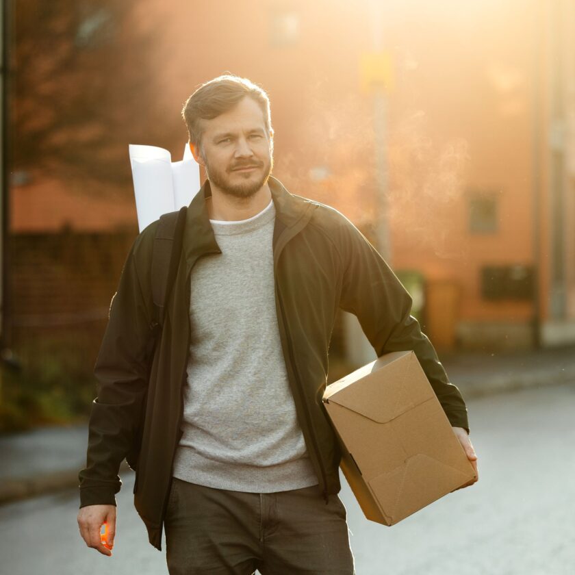 Nordlo-shared-man-walking-with-blue-prints-content-square-v11